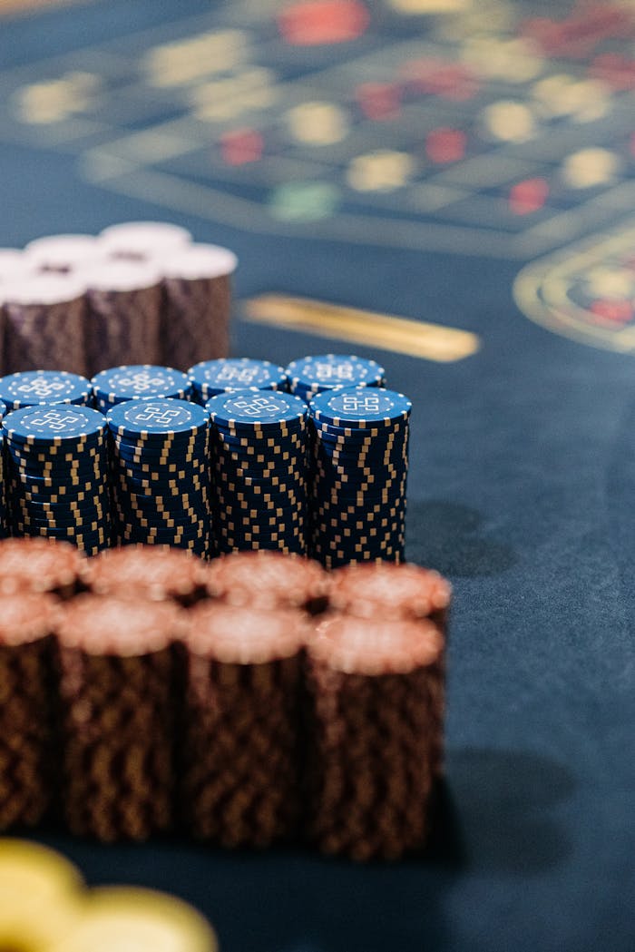 Close-up of colorful stacked casino chips on a roulette table.